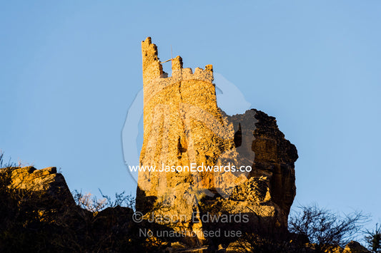 The ruins of an ancient mud brick village watchtower on a desert gorge mountainside. Misfat Al Abryeen, Al Hajar Mountains, Al Hamra, Ad Dakhiliyah Region, Sultanate of Oman.