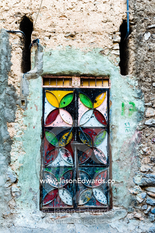 A painted and decorated steel door in an ancient mud brick village. Misfat Al Abryeen, Al Hajar Mountains, Al Hamra, Ad Dakhiliyah Region, Sultanate of Oman.