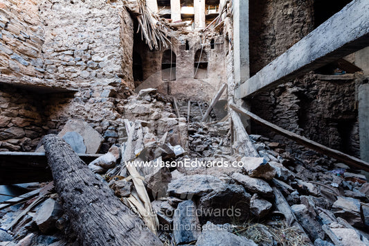 A collapsed palm frond ceiling and wall in an ancient mud brick village in the desert. Misfat Al Abryeen, Al Hajar Mountains, Al Hamra, Ad Dakhiliyah Region, Sultanate of Oman.