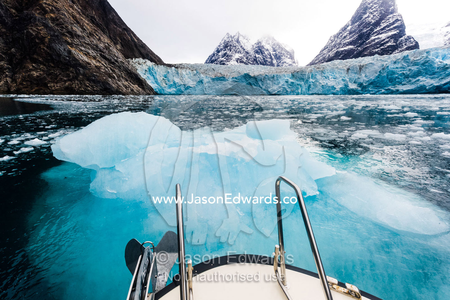 The bow of a boat colliding with an iceberg near a glacier. Fjord of Eternity, Maniitsoq, Sukkertoppen, Qeqqata Municipality, Greenland.
