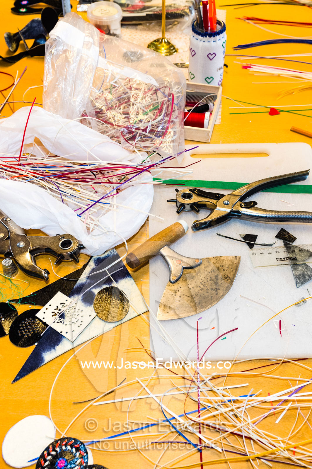 Tools and glue are used to sew seal pelts together to create artwork, souvenirs and home accessories. Kangaamiut, Gammel Sukkertoppen, Qeqqata Municipality, Greenland.