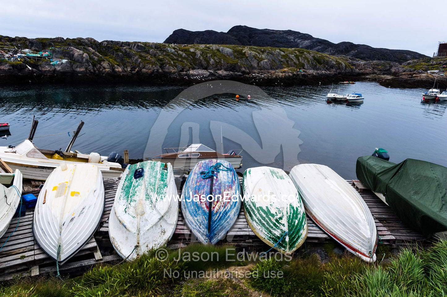 Small fishing boats turned upside down on a dock for repairs and maintenance. Kangaamiut, Gammel Sukkertoppen, Qeqqata Municipality, Greenland.