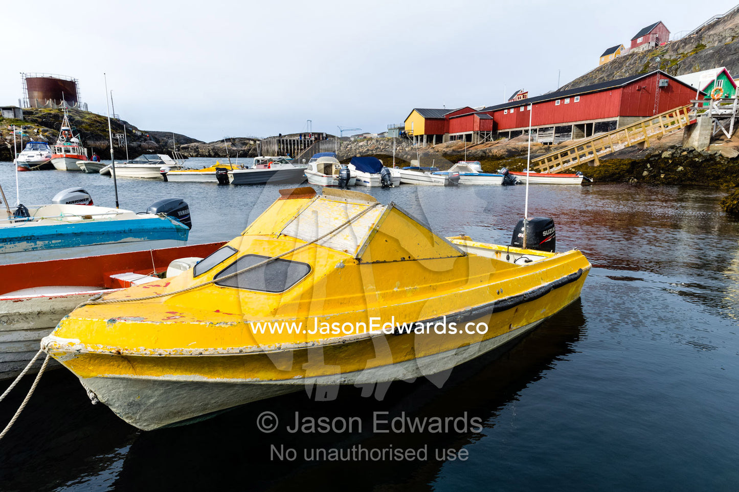 A small fishing and hunting boat moored in a sheltered harbor. Kangaamiut, Gammel Sukkertoppen, Qeqqata Municipality, Greenland.