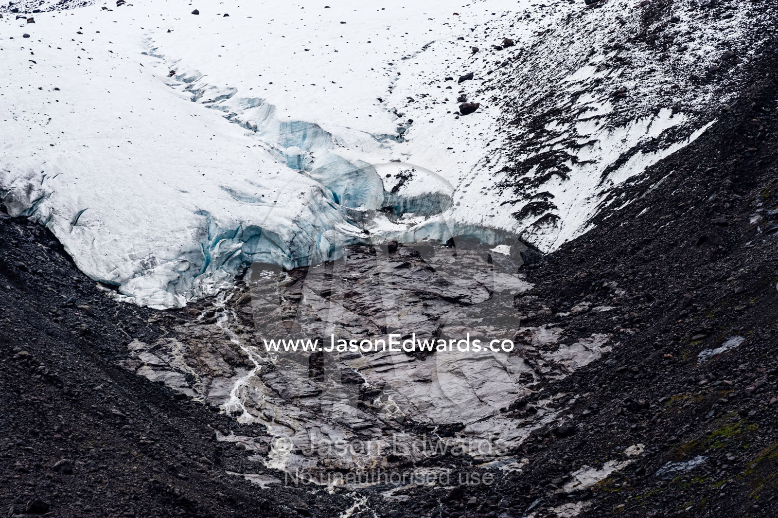 A glacier receding up a mountainside exposes barren rock. Fjord of Eternity, Maniitsoq, Sukkertoppen, Qeqqata Municipality, Greenland.