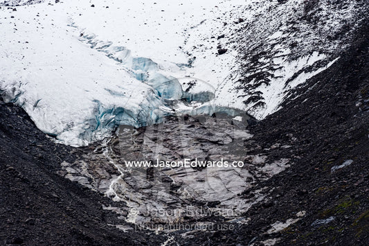 A glacier receding up a mountainside exposes barren rock. Fjord of Eternity, Maniitsoq, Sukkertoppen, Qeqqata Municipality, Greenland.