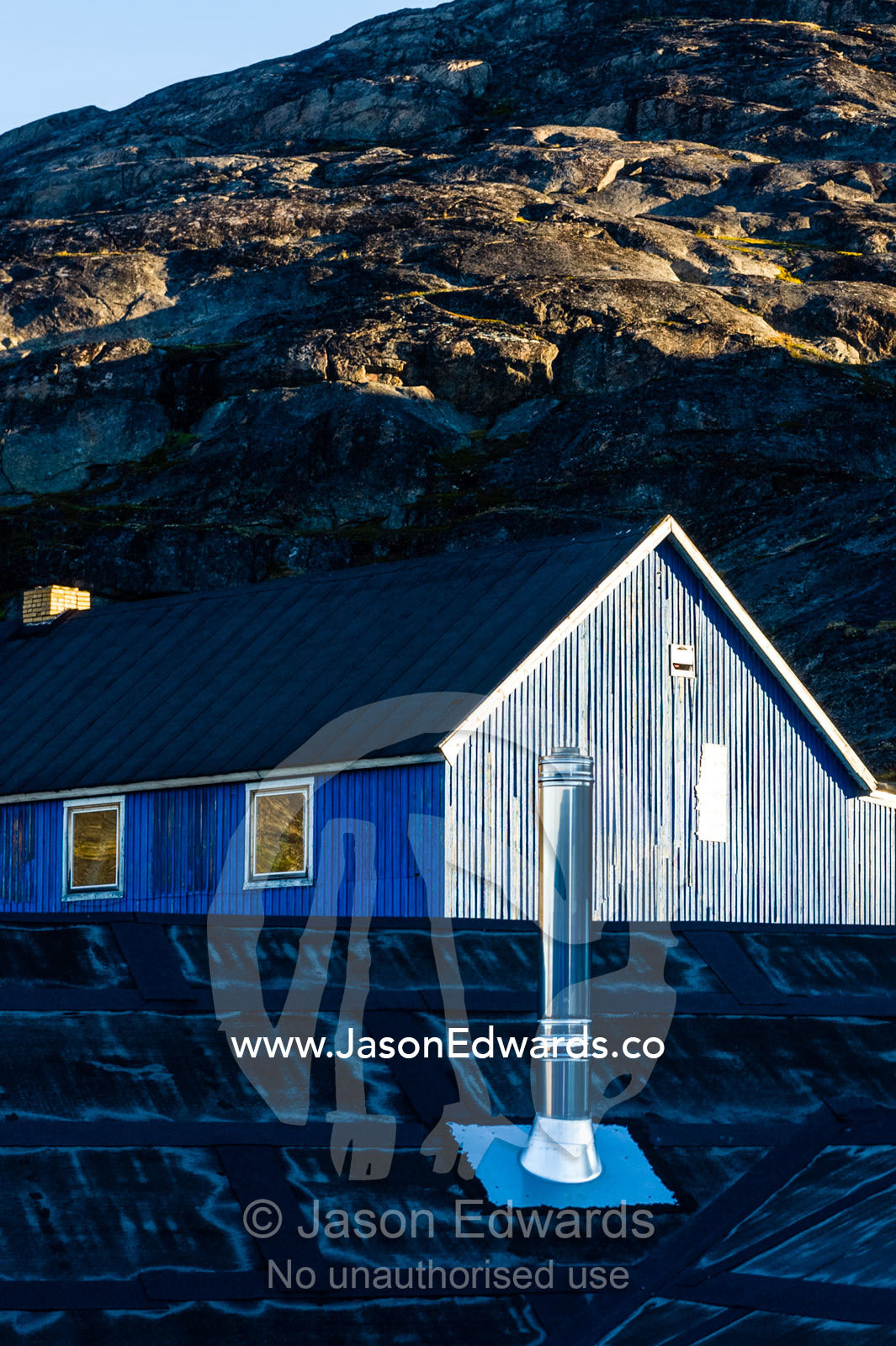 A stainless steel chimney rises from the roof of a village home. Kangaamiut, Gammel Sukkertoppen, Qeqqata Municipality, Greenland.
