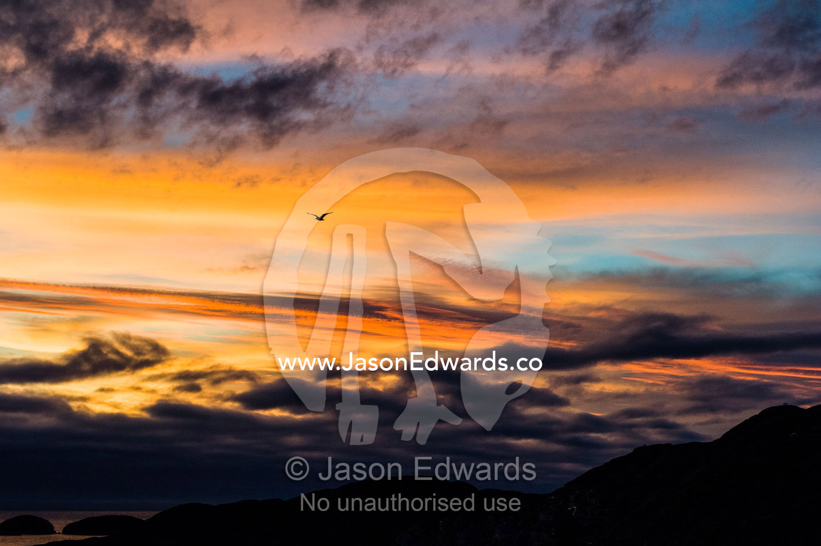 Orange hues predominate an altostratus cloudscape at sunset. Kangaamiut, Gammel Sukkertoppen, Qeqqata Municipality, Greenland.