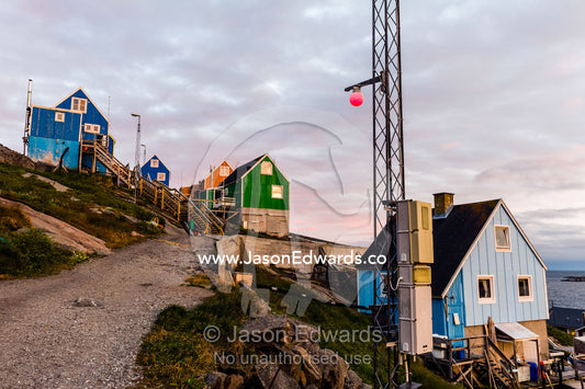 A quiet village street lined with cottages on an Arctic island. Kangaamiut, Gammel Sukkertoppen, Qeqqata Municipality, Greenland.
