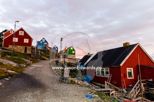 A quiet village street lined with cottages on an Arctic island. Kangaamiut, Gammel Sukkertoppen, Qeqqata Municipality, Greenland.