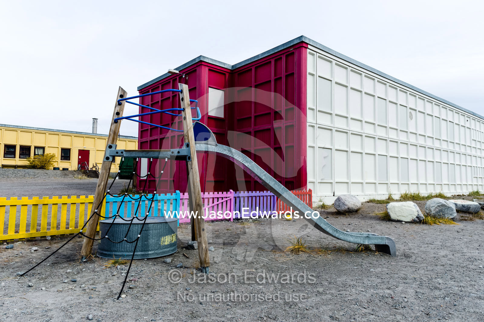 A slide and climbing frame in the playground of an elementary school in an arctic village. Kangerlussuaq, Qeqqata Municipality, Greenland.