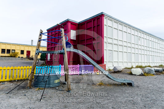 A slide and climbing frame in the playground of an elementary school in an arctic village. Kangerlussuaq, Qeqqata Municipality, Greenland.