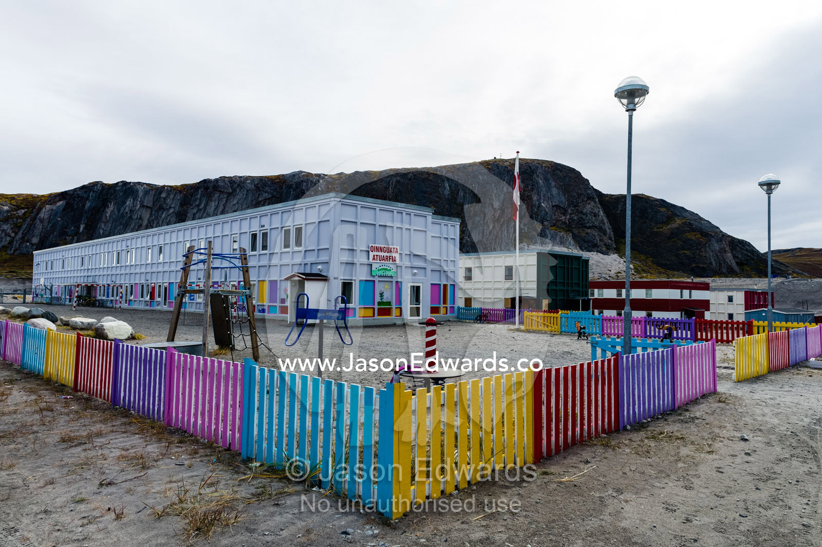 A slide and climbing frame in the playground of an elementary school in an arctic village. Kangerlussuaq, Qeqqata Municipality, Greenland.