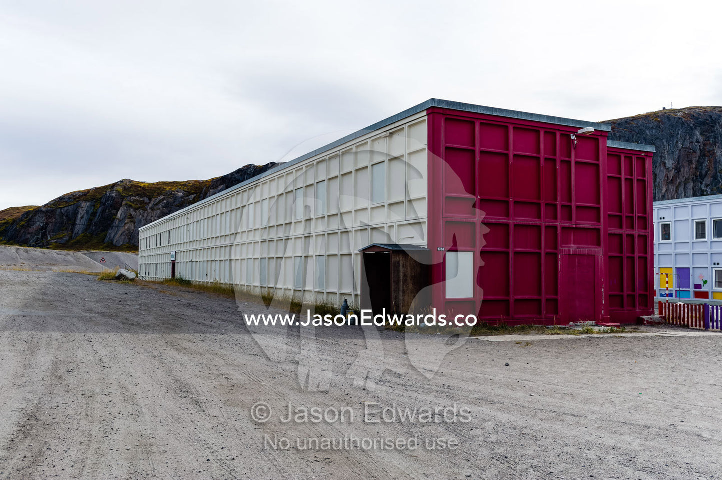 An arctic village school building designed in a cube to survive winter storms. Kangerlussuaq, Qeqqata Municipality, Greenland.