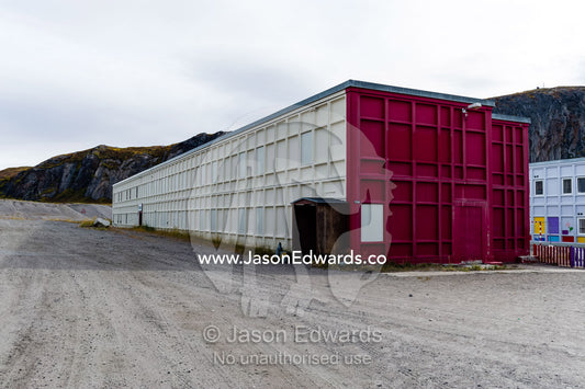 An arctic village school building designed in a cube to survive winter storms. Kangerlussuaq, Qeqqata Municipality, Greenland.