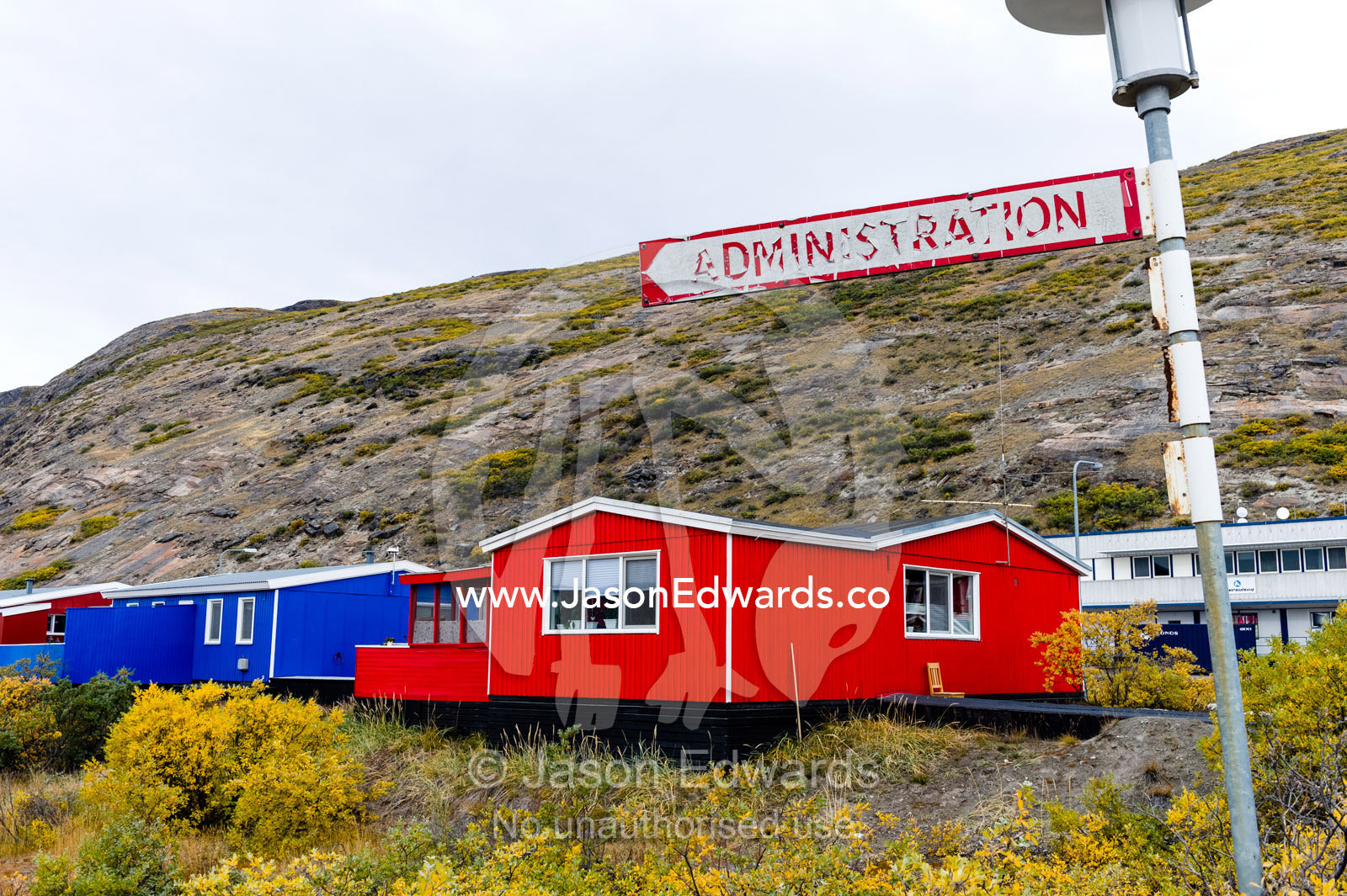 A peeling and weathered Administration sign in an arctic village. Kangerlussuaq, Qeqqata Municipality, Greenland.