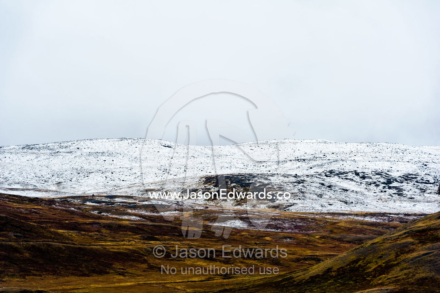 Autumn's first dusting of snow on low hills over the tundra. Greenland Ice Sheet, Qeqqata Municipality, Kangerlussuaq, Greenland.