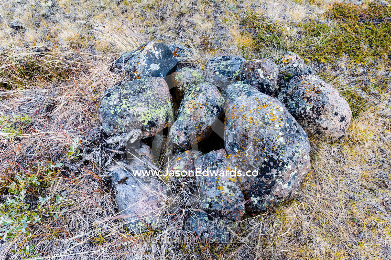 A stone cairn used as a meat locker for Inuit hunters on the Arctic tundra. Ammalortup Nunaa Highland, Kangerlussuaq, Qeqqata Municipality, Greenland.