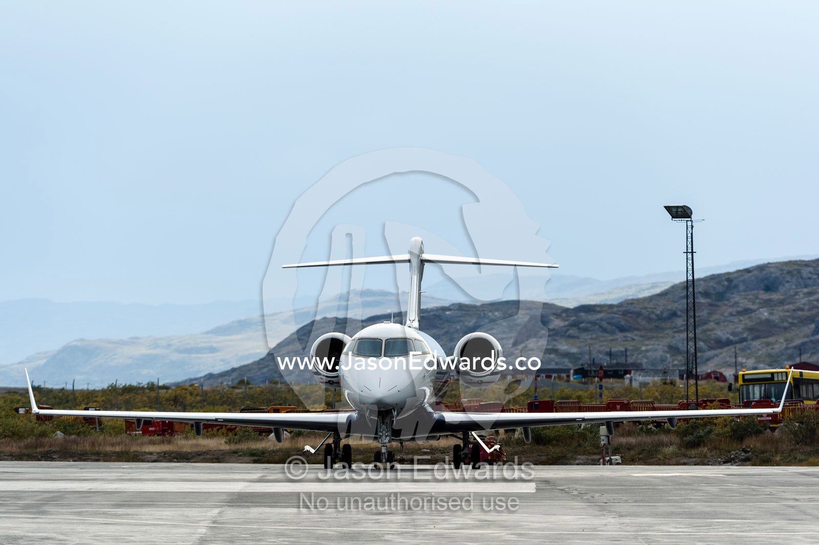 The elegant lines of a small jet parked on the tarmac of an arctic airfield. Kangerlussuaq Airport, Kangerlussuaq, Qeqqata Municipality, Greenland.