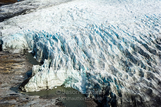 Pressure ridges and crevasse scar the surface of a glacier on the Greenland Ice Sheet. Russell Glacier, Greenland Ice Sheet, Qeqqata Municipality, Kangerlussuaq, Greenland.