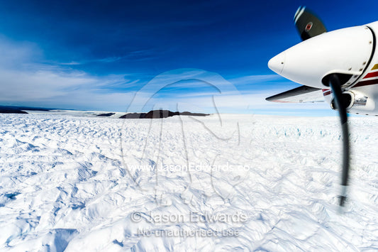The propeller of a small plane flying over the Greenland Ice Sheet. Russell Glacier, Greenland Ice Sheet, Qeqqata Municipality, Kangerlussuaq, Greenland.