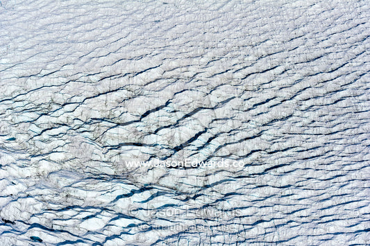 Pressure ridges and crevasse scar the surface of a glacier on the Greenland Ice Sheet. Greenland Ice Sheet, Qeqqata Municipality, Kangerlussuaq, Greenland.