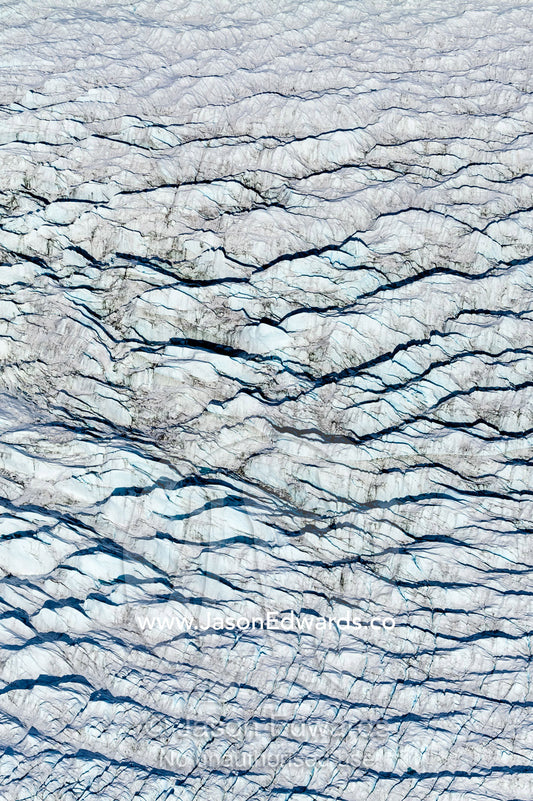 Pressure ridges and crevasse scar the surface of a glacier on the Greenland Ice Sheet. Greenland Ice Sheet, Qeqqata Municipality, Kangerlussuaq, Greenland.