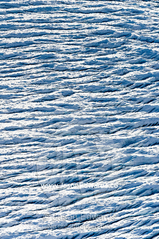 Pressure ridges and crevasse scar the surface of a glacier on the Greenland Ice Sheet. Greenland Ice Sheet, Qeqqata Municipality, Kangerlussuaq, Greenland.