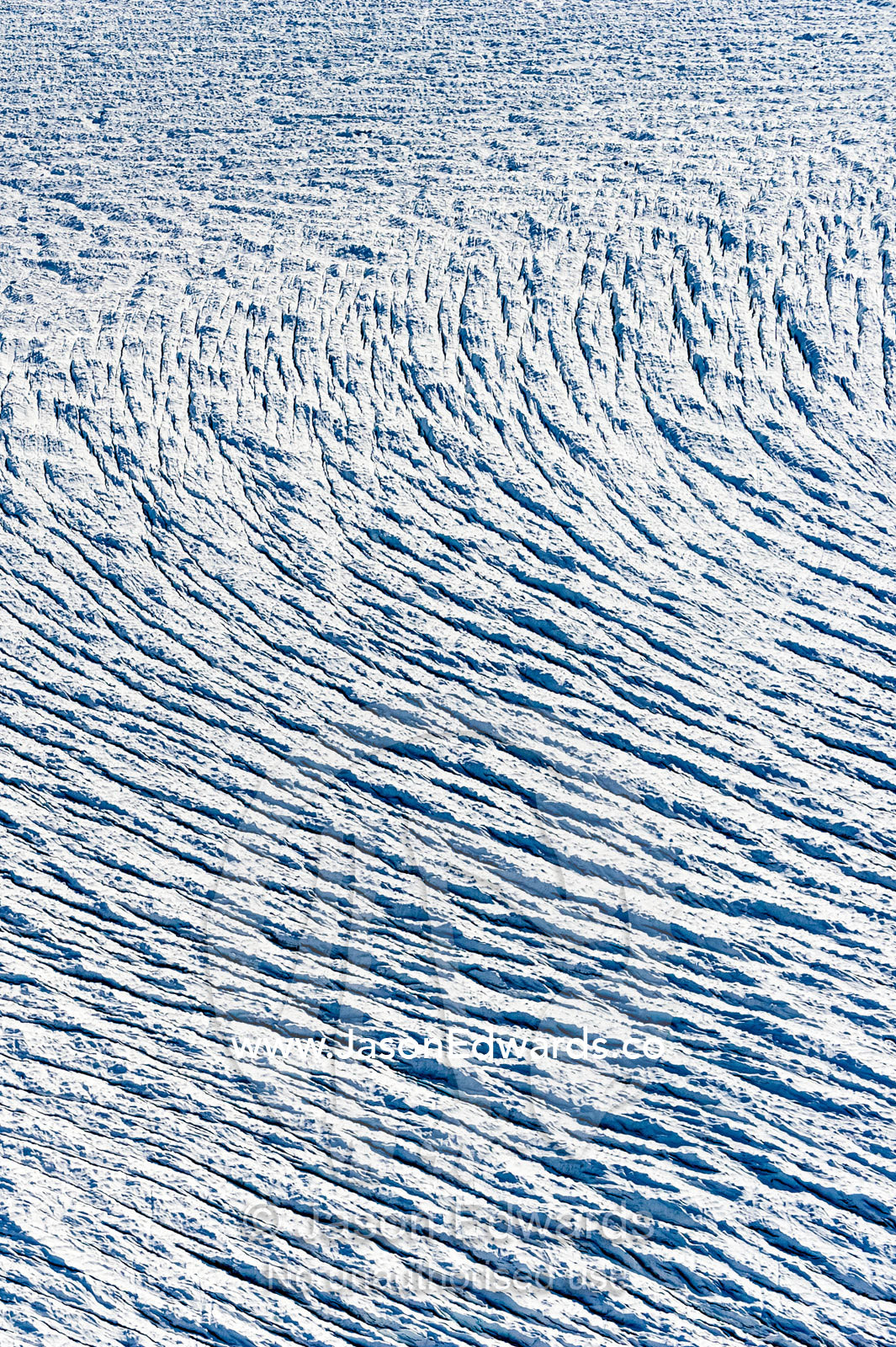 Pressure ridges and crevasse scar the surface of a glacier on the Greenland Ice Sheet. Greenland Ice Sheet, Qeqqata Municipality, Kangerlussuaq, Greenland.