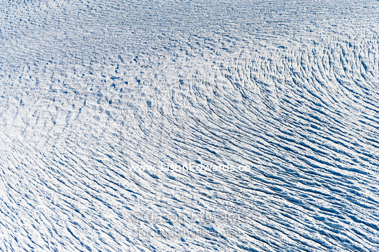 Pressure ridges and crevasse scar the surface of a glacier on the Greenland Ice Sheet Greenland Ice Sheet, Qeqqata Municipality, Kangerlussuaq, Greenland.