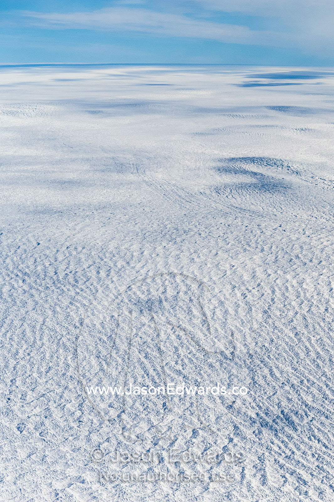 Pressure ridges and crevasse scar the surface of a glacier on the Greenland Ice Sheet. Greenland Ice Sheet, Qeqqata Municipality, Kangerlussuaq, Greenland.