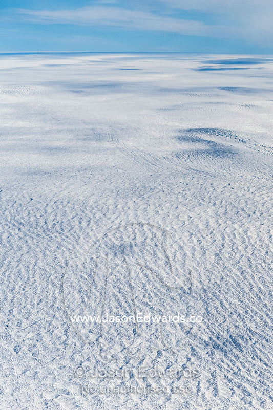 Pressure ridges and crevasse scar the surface of a glacier on the Greenland Ice Sheet. Greenland Ice Sheet, Qeqqata Municipality, Kangerlussuaq, Greenland.
