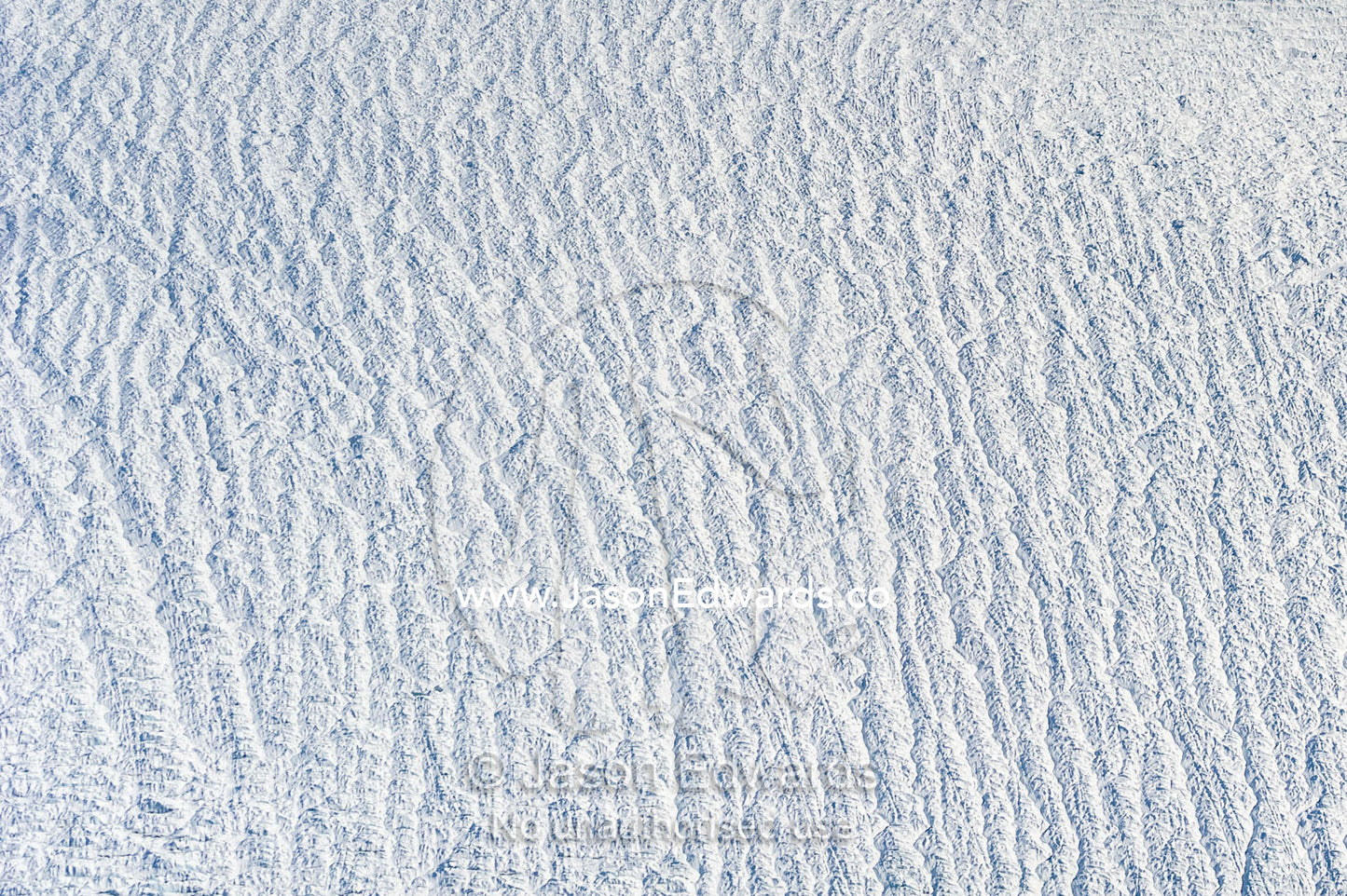 Pressure ridges and crevasse scar the surface of a glacier on the Greenland Ice Sheet. Greenland Ice Sheet, Qeqqata Municipality, Kangerlussuaq, Greenland.
