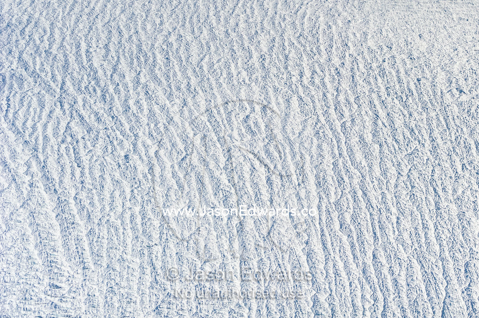 Pressure ridges and crevasse scar the surface of a glacier on the Greenland Ice Sheet. Greenland Ice Sheet, Qeqqata Municipality, Kangerlussuaq, Greenland.