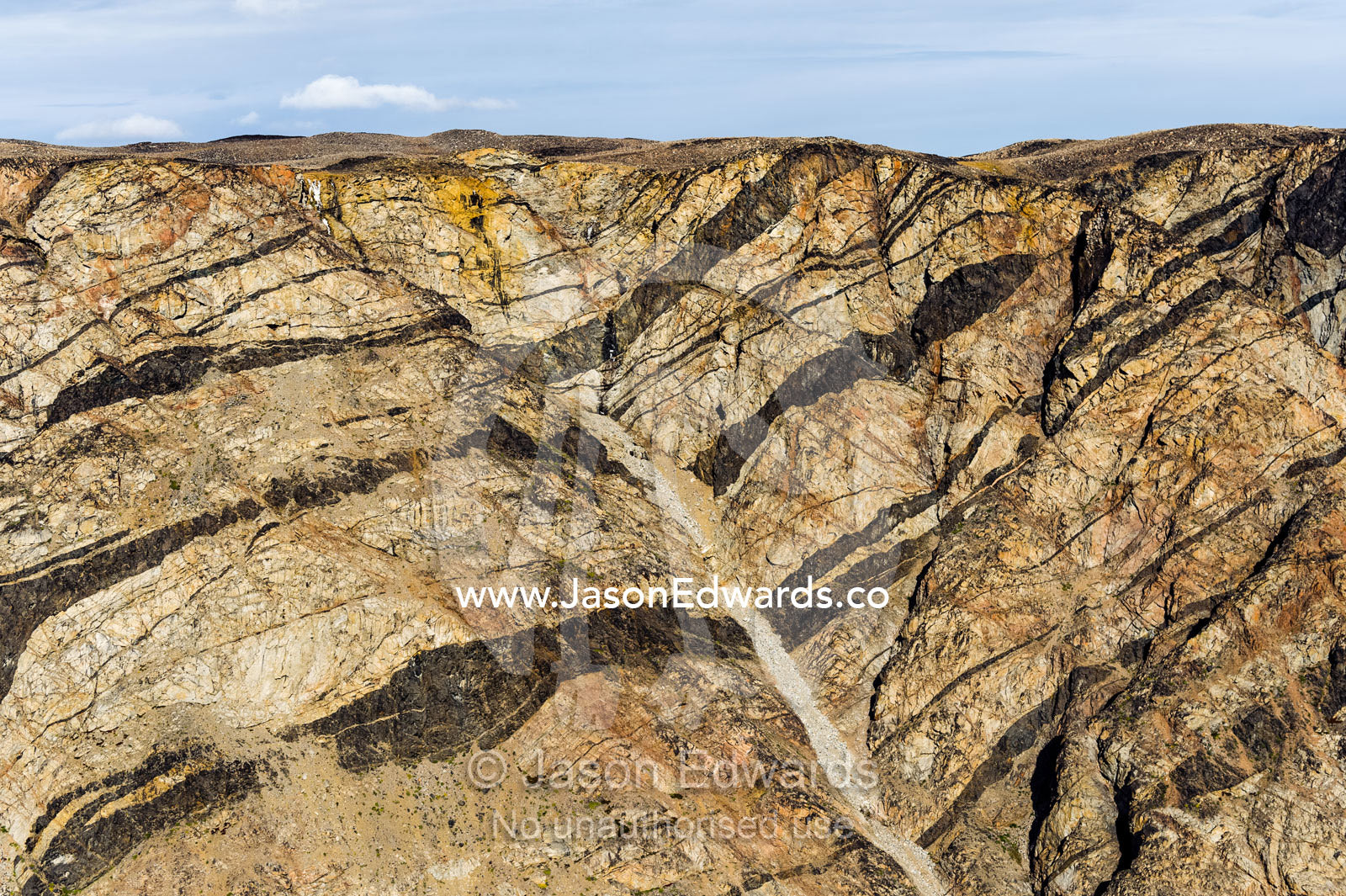 Folded layers of rock and pressure ridges in a cliff face. Tarajornitsut Highlands, Qeqqata Municipality, Kangerlussuaq, Greenland.