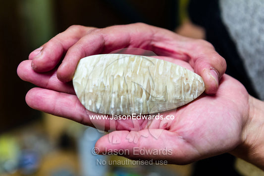 An artist displays the jewelry she carved from Musk Ox bone. Kangerlussuaq, Qeqqata Municipality, Greenland.
