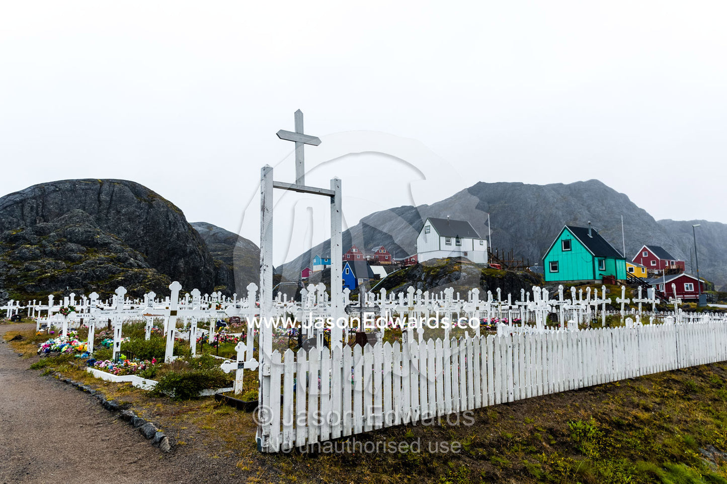 A crucifix at the gate of a fishing village cemetery. Maniitsoq, Sukkertoppen, Qeqqata Municipality, Greenland.