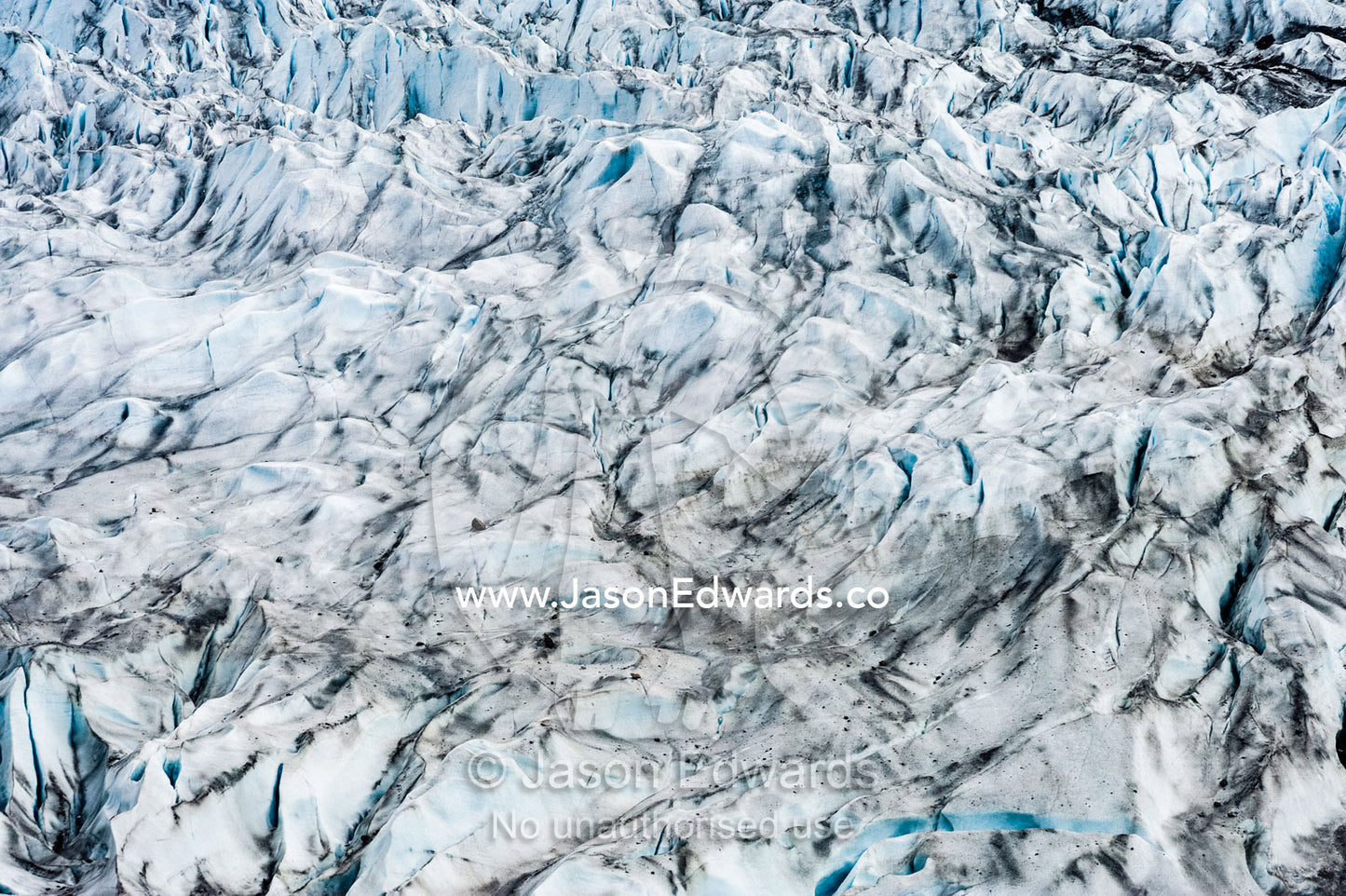 Pressure ridges and crevasse scar the surface of a glacier. Fjord of Eternity, Maniitsoq, Sukkertoppen, Qeqqata Municipality, Greenland.