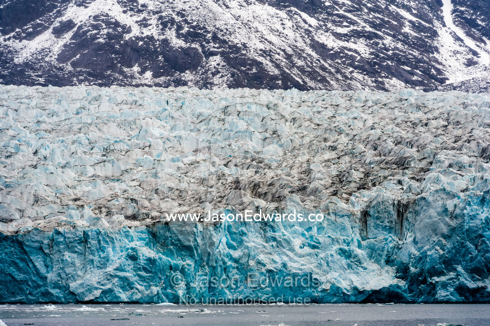Pressure ridges and crevasse scar the surface of a glacier fracture zone in a fjord. Fjord of Eternity, Maniitsoq, Sukkertoppen, Qeqqata Municipality, Greenland.