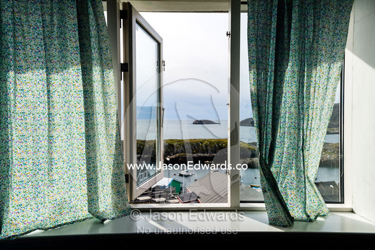 A school classroom window overlooking a village harbor. Kangaamiut, Gammel Sukkertoppen, Qeqqata Municipality, Greenland.