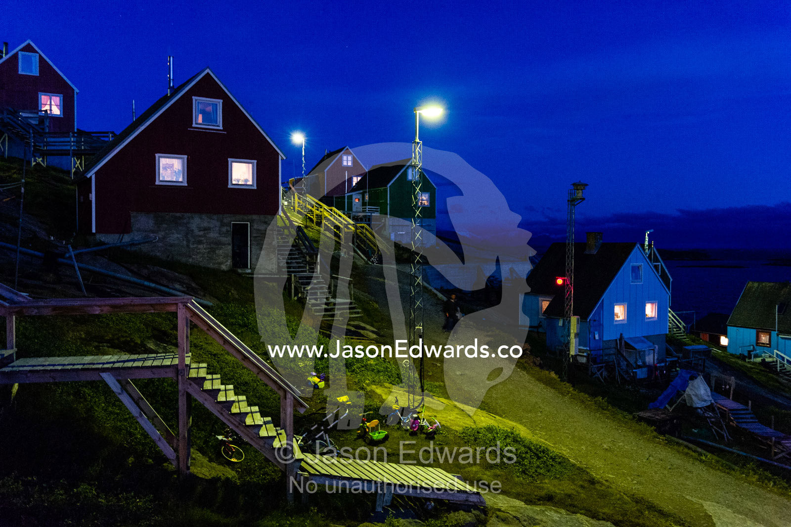 Stairs leading to cottages in an arctic village at night. Kangaamiut, Gammel Sukkertoppen, Qeqqata Municipality, Greenland.
