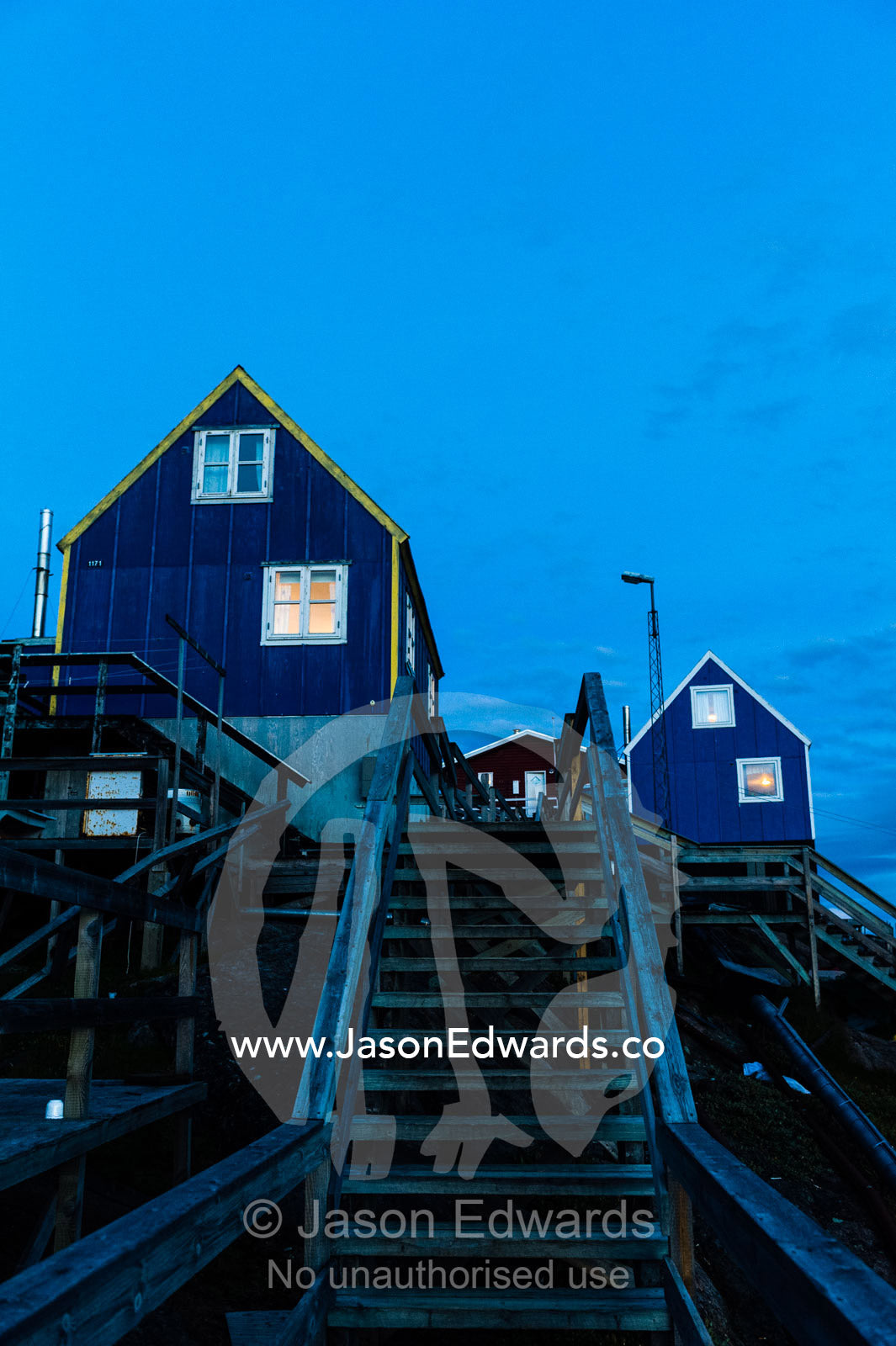 Stairs leading to cottages in an arctic village at night. Kangaamiut, Gammel Sukkertoppen, Qeqqata Municipality, Greenland.