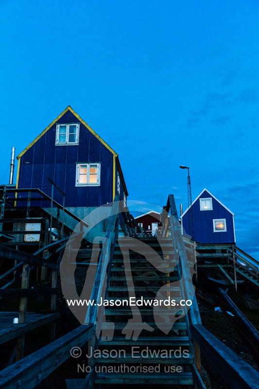 Stairs leading to cottages in an arctic village at night. Kangaamiut, Gammel Sukkertoppen, Qeqqata Municipality, Greenland.