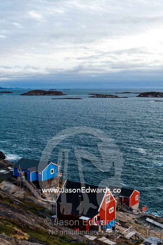 Cottages in an island fishing village overlook the ocean. Davis Strait, Kangaamiut, Gammel Sukkertoppen, Qeqqata Municipality, Greenland.