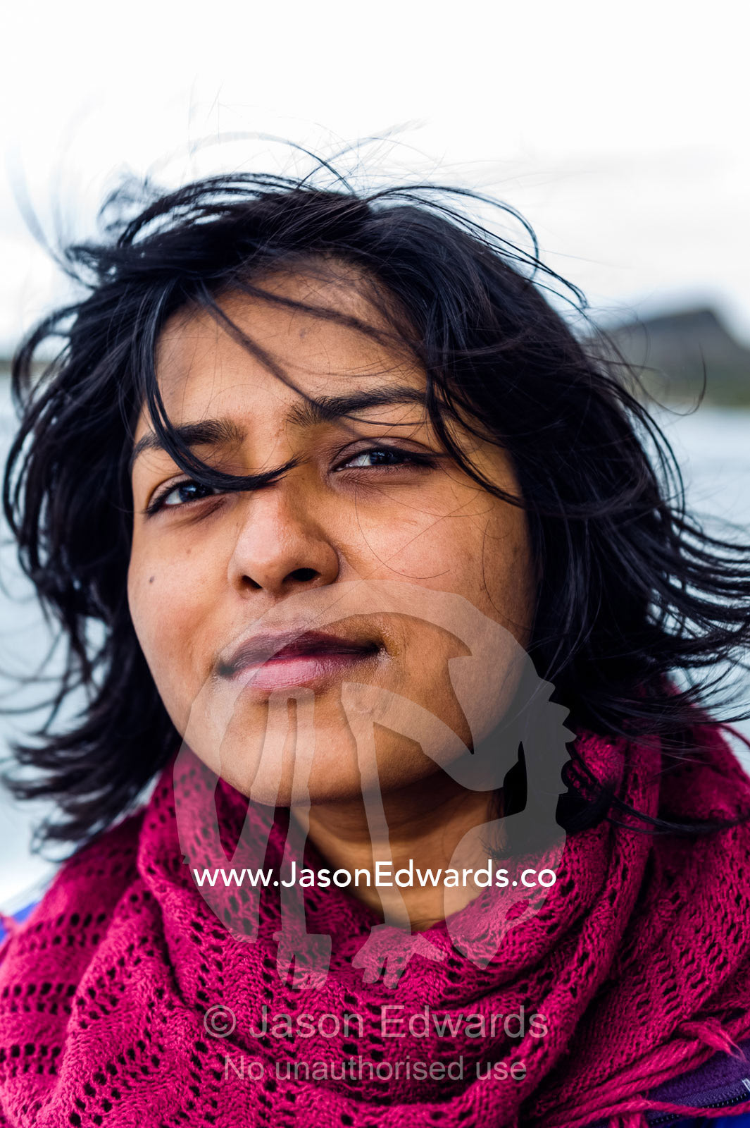 A woman from India standing in the icy Greenland wind. Davis Strait, Kangaamiut, Gammel Sukkertoppen, Qeqqata Municipality, Greenland.