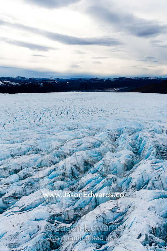 Pressure ridges and crevasse scar the surface of a glacier on the Greenland Ice Sheet. Russell Glacier, Greenland Ice Sheet, Qeqqata Municipality, Kangerlussuaq, Greenland.