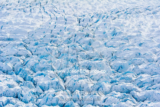 Pressure ridges and crevasse scar the surface of a glacier on the Greenland Ice Sheet. Russell Glacier, Greenland Ice Sheet, Qeqqata Municipality, Kangerlussuaq, Greenland.