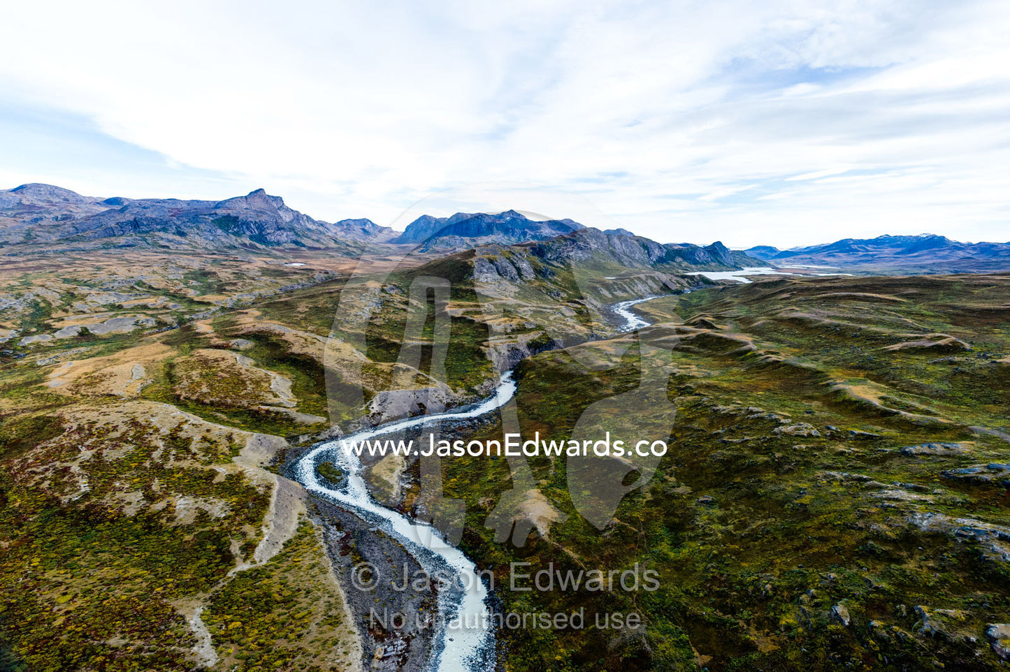 A winding river snakes it's way across a highland tundra valley. Tarajornitsut Highlands, Qeqqata Municipality, Kangerlussuaq, Greenland.