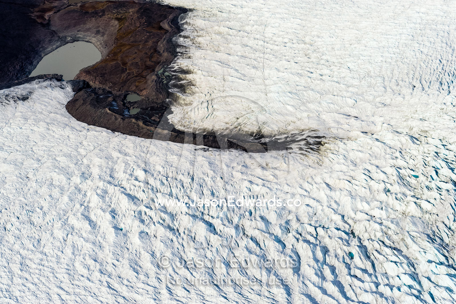 Pressure ridges in a glacier build up around an island in the Greenland Ice Sheet. Greenland Ice Sheet, Qeqqata Municipality, Kangerlussuaq, Greenland.