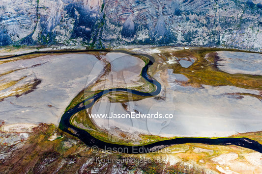 A winding river snakes its way across a highland tundra valley floor. Tarajornitsut Highlands, Qeqqata Municipality, Kangerlussuaq, Greenland.