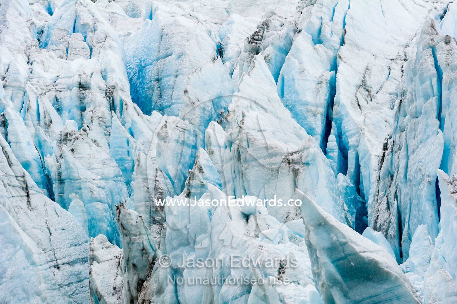 Treacherous jagged ice spires on a glacier fracture zone known as serac. Greenland Ice Sheet, Qeqqata Municipality, Kangerlussuaq, Greenland.